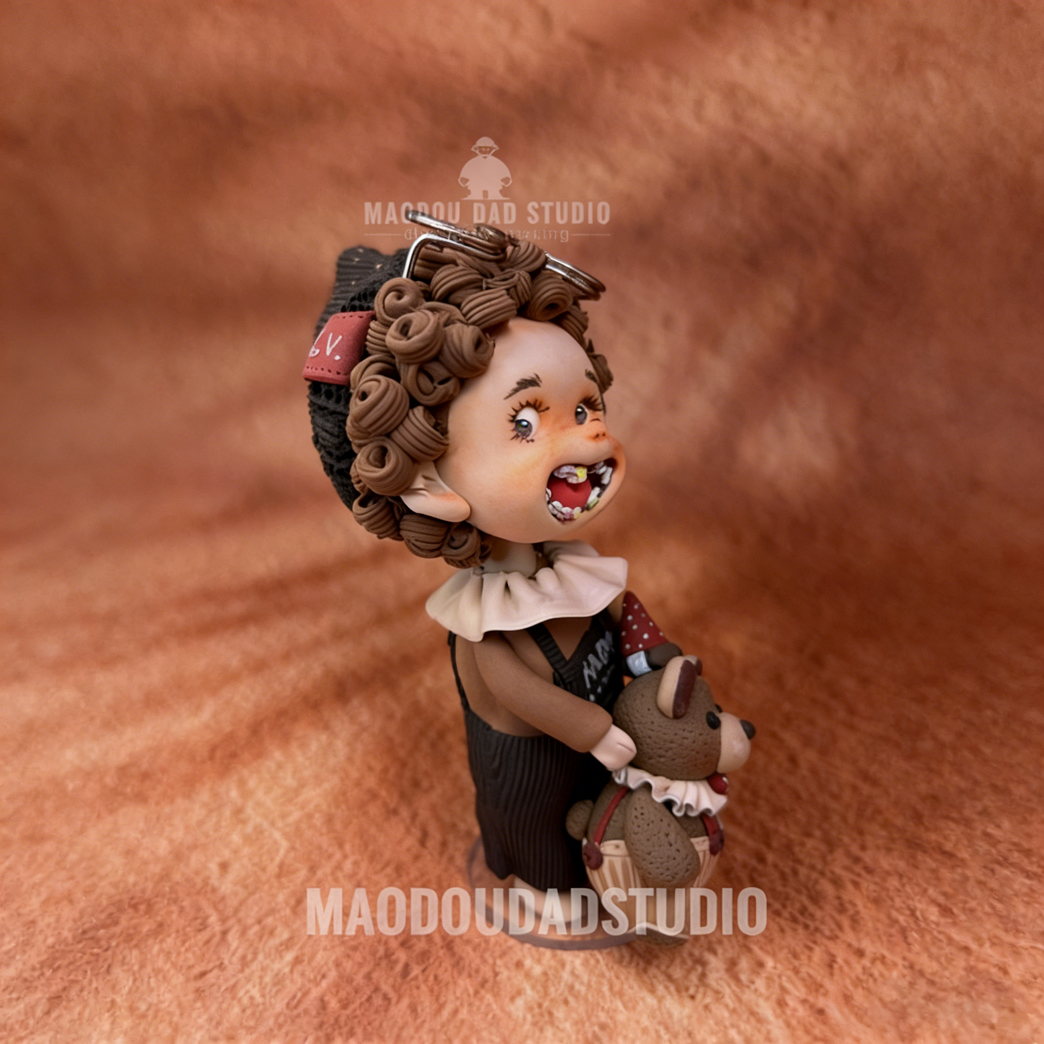 Braces Cutie artisan clay figurine – lifestyle shot on desk showing display base